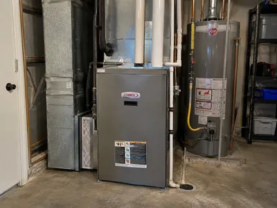 Newly installed furnace and water heater in a home utility closet